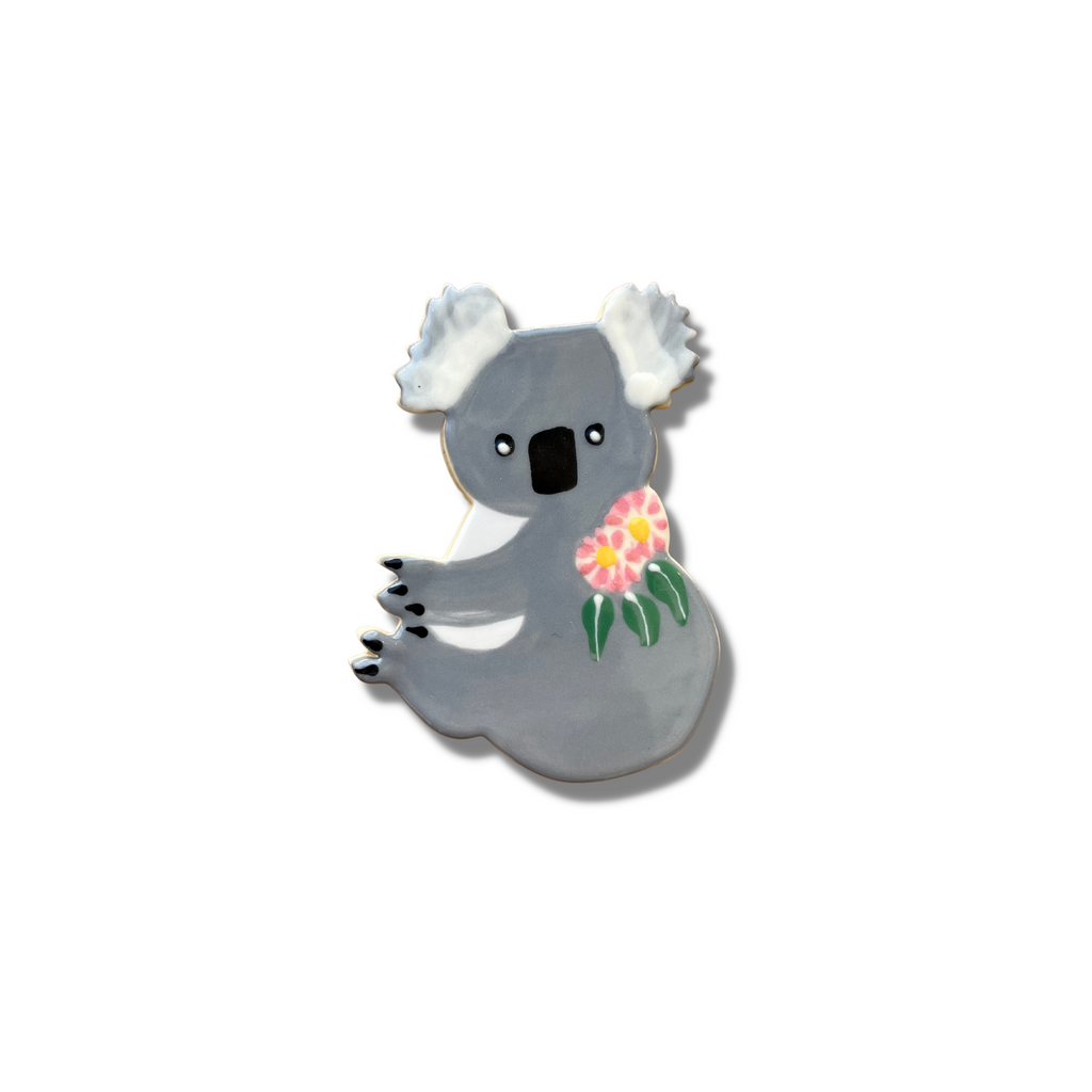 Handmade and painted ceramic Koala magnet with Eucalypt leaves and flowers. Handmade in Brisbane by Paper Boat Press